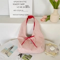 Close-up of red and white plaid tote bag with ribbon bow and elegant French props - Red