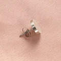 Close-up of silver round brushed stainless steel studs on pink woven fabric - Steel Color Brushed Stud Earring / 1 Piece