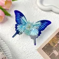 Blue gradient butterfly hair claw clip with gold spring on a decorative stone surface - Blue Butterfly