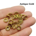 Detailed view of antique gold Tibetan silver spacer beads with auspicious cloud patterns - Antique Gold