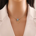 Detail of gold twisted chain with blue evil eye bead and P letter pendant on a model - Letter P (N1339)