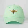 Close-up of mint green cotton baseball cap with embroidered bee and six-panel structure - One Size / Light Green