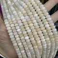 Detail of cream natural stone abacus beads showing smooth texture and translucent finish - 5*8mm (Per Strand) / Beige