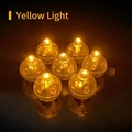 Close-up of seven small LED light beads with warm yellow glow for vintage lantern hairpins - F00 Spare Light Ball - Warm