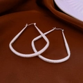 Macro view of matte silver U-shaped geometric earrings on elegant brown satin - 31# Silver Matte Geometric U-Shape Modern Earring