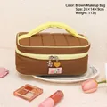 Quilted brown makeup bag with yellow handle and floral charms for cosmetics storage - Brown Quilted Handbag