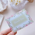 Floral greeting card with pink roses and Thank You text held by a hand - Rose Garden