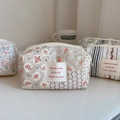 Detailed close-up of French floral quilted cotton pouches with various vintage patterns - Beige with Geometric Floral