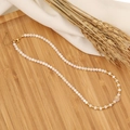 Detail of beaded necklace with white pearls and pink flower pendant on wooden tray - 5# Pink Flower
