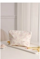 Detailed close-up of a floral canvas makeup bag with pink roses and woven logo label - Light Pink