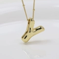 Macro shot of gold-plated puffy letter Y pendant necklace with high polished finish - Letter Y (Necklace)