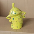 Lime green ceramic canister with colorful spots and unique arm-shaped handles - Yellow