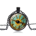 Black metal necklace with round glass pendant featuring a green chameleon eye design - Black Base - Chameleon Eye