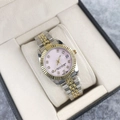 Detail of luxury two-tone women's watch with pink dial, diamond indices, and date window - Two Tone Gold Pink