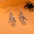 Silver articulated human skeleton drop earrings on an orange card for Halloween - FX190 (Articulated Skeleton)