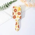 Detail of colorful floral cushion hairbrush with orange and yellow flower patterns - Style D