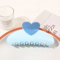 Detail of light blue heart hair claw clip with large teeth on a decorative tray - Heart Semicircle / Sky Blue
