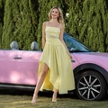 Close-up of yellow strap dress with lace waist and irregular hem by a pink car - XS / Yellow