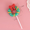 Christmas wreath cake topper with red bow and colorful polka dots on a white stick - Wreath