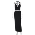 Detailed front view of black halter neck crop top and high waist slim fit maxi skirt set - S / Black