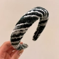 Detail showing the green and white knitted texture with a handmade label on the headband - Blue and White Colorful