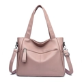 Close-up of pink leather handbag texture and decorative engraved typography detail - Light Purple