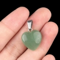 Green natural crystal heart pendant 16mm with silver clasp held in hand - Green Aventurine