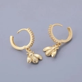 Detail of gold bee drop earrings with sparkling zircon stones on a dark grey background - Bee - Gold