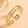 Detailed macro of a double-layered gold heart bracelet with sparkling zircon accents - Gold Double Strand Inlaid Heart Style (H820)