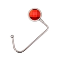 Close-up of portable silver metal bag hook featuring a faceted red gemstone inlay - Red