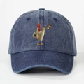 Close-up of a washed denim baseball cap with a cartoon rooster print on white background - Navy Blue