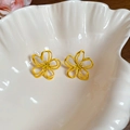 Detail shot of yellow flower shaped hollow earrings placed in a white ceramic shell bowl - 28# Silver Earring Post - Yellow Hollow Five-petal Flower