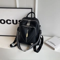 Close-up of black litchi grain leather backpack with V-stitch and woven strap - Black