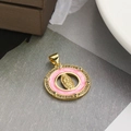 Macro detail of a golden Virgin Mary pendant with pink enamel and zircon inlay - Pink Round