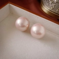 Detail of two round pink faux pearls with pearlescent luster in a velvet jewelry box - Pink