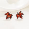 Detail of leaf-shaped earrings with red crystals and dark grey finish on white silk - Gun Black Red Rhinestone Leaf Stud Earrings (10476)