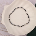 Handmade beaded bracelet with black, silver, and blue-grey beads on a white shell tray - Style 9-Black and Silver Seed Beads