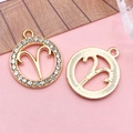Gold Aries zodiac pendant set with sparkling rhinestones and textured metal finish - Aries