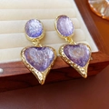 Vintage style gold earrings with purple resin hearts and oval textures on a beige tray - Light Purple