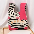 Pink knit tote bag with zebra print and BE HAPPY text on a white display background - Be Happy Rose Red
