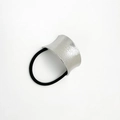 Detail of silver brushed metal U-shaped charm on a black elastic hair tie for women - Sand Silver