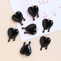 Detail of 6 black acrylic heart pendants with gold loops and creative lava drip design - Black