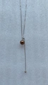 Minimalist adjustable silver long necklace with brown bead pendant and tassel detail - Bronze