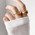 Golden sun and moon signet rings with embossed patterns and small diamonds on hand - Square Sunburst Style