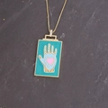 Macro shot of gold square pendant with blue Hamsa hand and pink heart on stone background - 5# Blue Palm