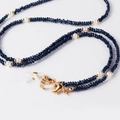 Detail of dark blue crystal beads and white pearls on a gold-plated glasses chain - Navy Blue
