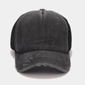 Macro shot of retro washed canvas trucker hat showing distressed brim and mesh panel - Black and Black
