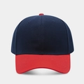 Detail of navy crown and red visor stitching on a twill cotton baseball cap - Navy + Bright Red Brim