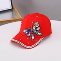 Close-up of bright red cotton baseball cap with colorful rhinestone butterfly design - One Size / Red