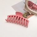 Close-up of matte pink rectangular hair claw clip on a magazine with a soft aesthetic - Keel / Girl Pink